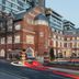The Lalit London hotel in London, red brick historic building with modern glass tower backdrop