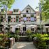 Fletcher Hotel Restaurant Boschoord in Oisterwijk with garden patio and umbrellas outside the facade