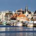 Hôtel Mercure Trouville-sur-Mer overlooking Trouville-sur-Mer harbor with boats and waterfront buildings