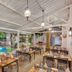 Club Mahindra Emerald Palms, Goa, indoor poolside dining area with tables beside a lit swimming pool