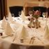 Hotel Kruse Zum Hollotal in Grapperhausen: elegant round banquet table set with folded napkins and floral centerpiece