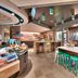 Tru by Hilton Clearfield Hill Air Force Base breakfast area with teal stools and large windows