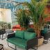 Tauá Hotel & Convention Atibaia lounge with green sofas, potted palm, and outdoor seating in Atibaia