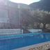 Casa Siciliana Altarbiah in Trabia: outdoor pool with mountain views and palm trees