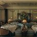 The Gleneagles Hotel, Auchterarder: elegant dining room with round tables, tufted sofas and floral centerpiece