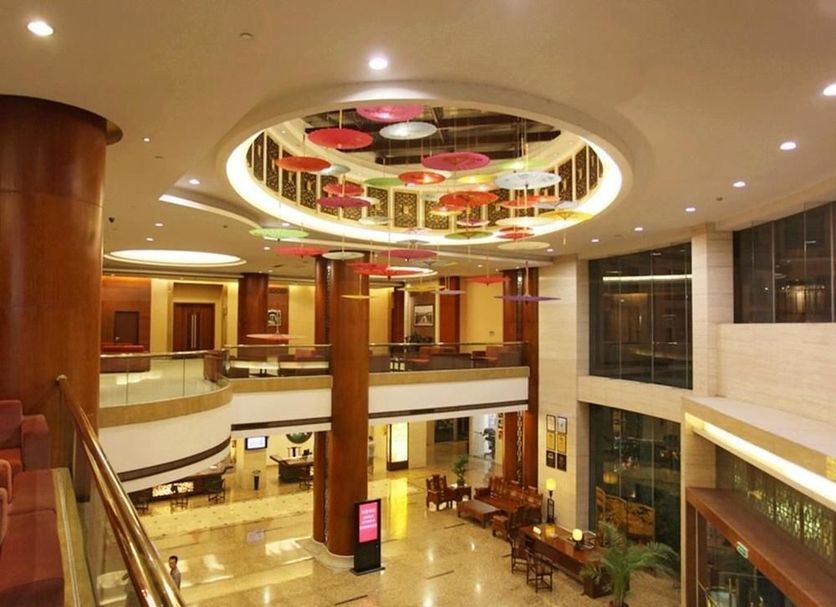 Gold River Side Hotel Jiaxing lobby with circular ceiling design, mezzanine, and glass walls