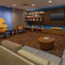 Courtyard by Marriott Cleveland Beachwood lobby lounge with TV, seating area, and blue accent wall
