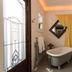 Stewart Inn Wausau bathroom with clawfoot tub, stained-glass door, and decorative mirror