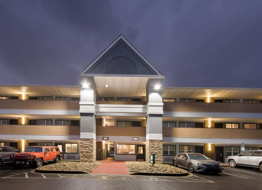 MainStay Suites Knoxville - Cedar Bluff in Farragut at dusk, exterior with covered entrance and parked cars