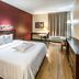 Red Roof Plus Long Island - Garden City room in Westbury with king bed, desk, TV and window seating