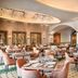 Secrets Tides Punta Cana in Uvero Alto restaurant with arched ceilings, tables and pink chairs
