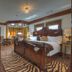The Victoria Bed & Breakfast in Bentonville, ornate bedroom with carved wood bed and zebra rug