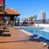 Champagnat Praia in Vila Velha: rooftop pool deck with lounge chairs and city view