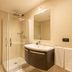 UNA Hotels Le Terrazze Treviso Hotel & Residence bathroom with glass shower and wall-mounted sink in Villorba