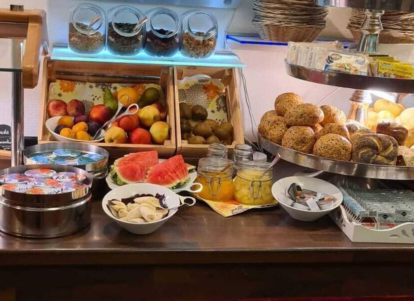 Hotel & Restaurant Wilhelm von Nassau, Diez breakfast buffet with fruit, pastries, yogurt, and condiments