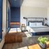 Hammetts Hotel in Newport guest room with king bed, sofa, and large windows with natural light.