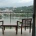 Oak Ray Heritage Hotel in Kandy balcony with two chairs and table overlooking lake and hillside city