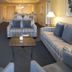 Waterside by Spinnaker Resorts living room with striped sofas, TV, coffee table and kitchen in Hilton Head Island