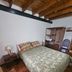Hostal de la Laguna in Ushuaia guest room with double bed, wooden beams and wardrobe