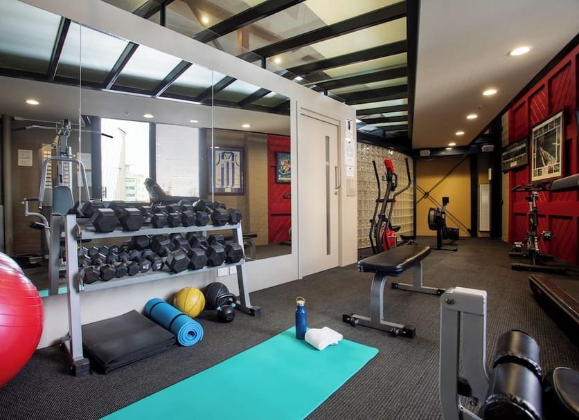 The Old Woolstore Apartment Hotel Hobart gym with dumbbells, exercise ball, benches and cardio equipment