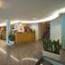 Hotel & Residence Parador in Cesenatico lobby with bar, seating area and staircase