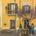 Hotel Il Tiglio in Castel di Sangro with yellow facade, balconies, and guests standing by the entrance
