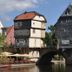 Zur Rotenfelsstube in Norheim, riverside hotel beside a stone bridge and calm water under a blue sky