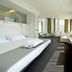 Mercure Nerocubo Rovereto room with sofa seating and large windows overlooking Rovereto