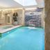 Indoor spa pool at H15 Palace, a Luxury Collection Hotel, Krakow, with stone walls and loungers