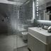 Lords of Verona Luxury Apartments bathroom with glass shower, floating vanity and modern mirror in Verona