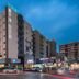 Hanting Hotel Dongguan Changan Wanda exterior at dusk in Dongguan, with streetfront shops and traffic lights