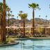 Kimpton Miralina Resort And Villas by IHG in Scottsdale: palm-lined pool with mountain views