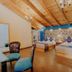 Hotel Cielo y Selva room with two beds, blue accent wall, and wood-beamed ceiling in San Cristóbal de las Casas