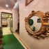 Housez 43 Kolkata hotel hallway with ornate wall mirror and green runner