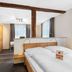 Schieners Hotel & Apfelhof Apartments in Wemding, modern apartment room with kitchenette and bed