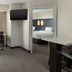 Residence Inn by Marriott Providence Coventry in West Greenwich suite with sofa, desk, TV, and bedroom doorway