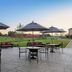 Towneplace Suites By Marriott Danville patio with tables, umbrellas and outdoor grill overlooking green lawn