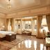 Taj Fateh Prakash Palace Udaipur guest room with lake-view windows, ornate bed and sitting area