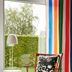 Ikea Hotell in Älmhult: colorful striped curtain, armchair, side table and floor lamp by a window