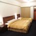 Sin Fu Business Hotel, Taichung City room with two twin beds, TV, and wardrobe