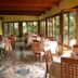 Hotel Rosa Del Tirreno in Quercianella dining room with tiled floor and large windows overlooking greenery