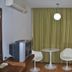 Suriwongse Hotel Bangkok room with curtained window, two chairs, small table and bed