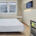 B&B Hotel Milano Cenisio Garibaldi room with double bed, city view window and wall-mounted TV in Milan