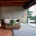Hotel-Apartamento Rural Atxurra in Bermeo: rustic terrace seating with wicker sofa, armchair, and sea view
