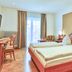 Zum Ochsen in Schallstadt guest room with double bed, desk, chairs and balcony doors