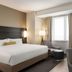 Residence Inn By Marriott New York Jfk Airport guest room in Queens with king bed, desk, chairs and window