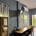 Aonang Sr Bungalow in Ao Nang room with desk, TV, air conditioner and open door to balcony