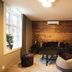 Home Again Apartments Nygata 1 in Stavanger, cozy lounge with wood wall, sofa, and window nook