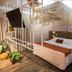 Camboriú Praia Hotel bedroom in Balneário Camboriú with four-poster bed and potted plants