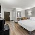 Studio 6 King of Prussia PA Philadelphia room with king bed, desk and chair, and wood-look flooring